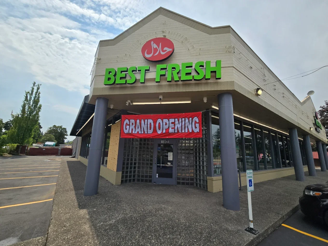 Exterior of Best Fresh International Market on SE Division Street with a HALAL sign and Grand Opening banner